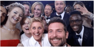 A selfie taken by Ellen Degeneres at the oscars that includes lots of different famous actors and actresses.